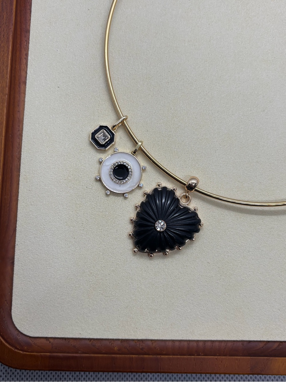 Gold Structured Necklace with Black Heart and White Charm